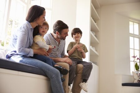 family sitting on window